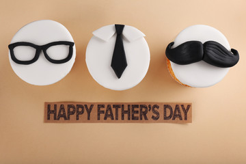 Delicious creative cupcakes on beige background