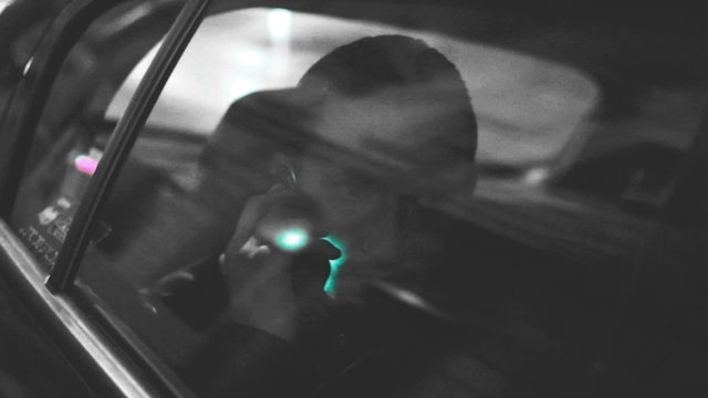 a man dials in the car. black and white symbolic of the picture with two flowers,man dials in the car, loaded, melancholic, lyrical look