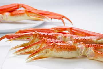 Boiled crab claws on a plate over white background