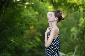 
Caucasian girl relaxing and enjoying life in forest's fresh air