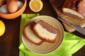 Delicious sweet cake bread in plate on wooden table closeup