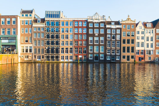 Buildings along the Damrak during the day in Amsterdam