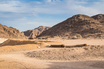 Fototapeta na wymiar Mountains of egyptian desert and bedouin village