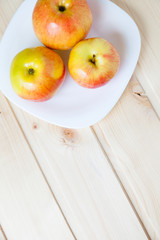 Apples in a bowl on a wooden table