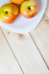 Apples in a bowl on a wooden table