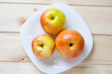 Apples in a bowl on a wooden table
