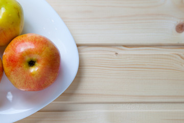 Apples in a bowl on a wooden table