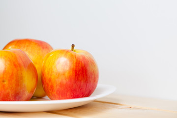 Apples in a bowl on a wooden table
