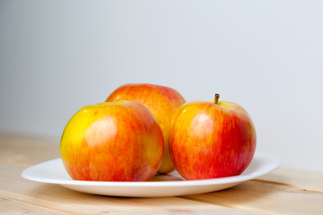 Apples in a bowl on a wooden table
