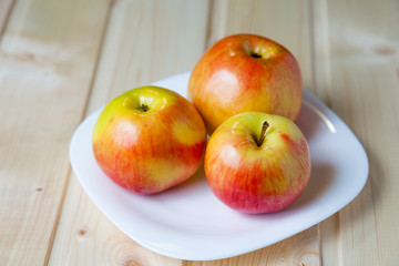 Apples in a bowl on a wooden table