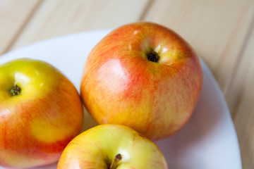 Apples in a bowl on a wooden table
