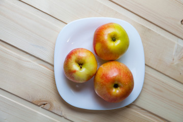 Apples in a bowl on a wooden table