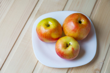 Apples in a bowl on a wooden table