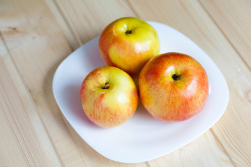 Apples in a bowl on a wooden table