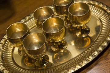 Brass small cups of alcohol with a tray