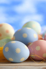 Easter eggs in pastel color on blue sky background