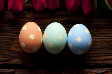 Three Easter eggs on wooden planks