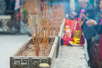 Burning joss stick put in chinese pot of temple