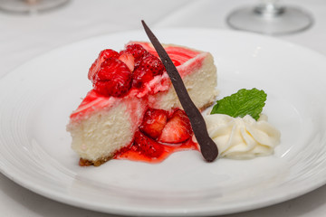 Cheesecake with Strawberries Chocolate and Mint Leaf