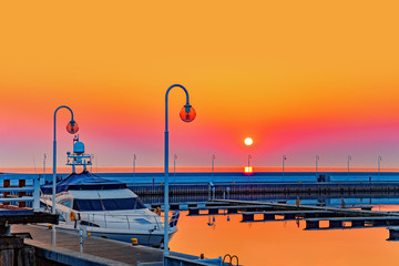 Marina with boat and calm in early morning light in pier. Sopot, Poland. - obrazy, fototapety, plakaty