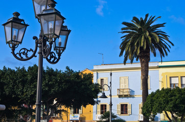 Fototapeta na wymiar Lantern if front of colorful buildings at Carloforte harbor, San Pietro island, Sardinia, Italy