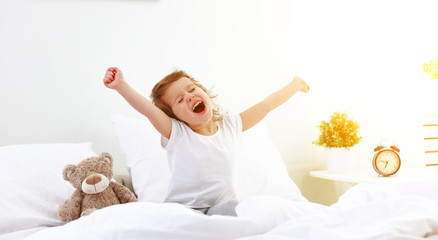 morning awakening child girl in bed