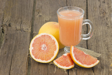 grapefruit juice and frish fruits on wooden background