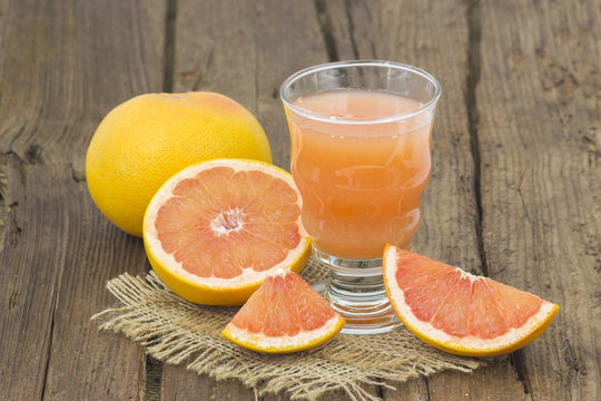 grapefruit juice and frish fruits on wooden background