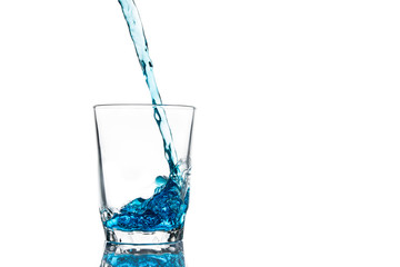 Pouring water into glass isolated