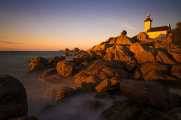 atmospheric Sunset on the beach of pontusval with rocks an lighthouse; Sonnenuntergang F, Bretagne, Brignogan-Plages, Leuchtturm Pontusval)