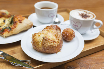 Brioche on background of cups with hearts