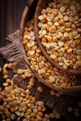 Yellow dry peas in wooden bowl