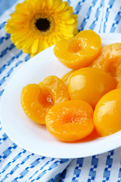 Cut peaches in syrup and a yellow gerber