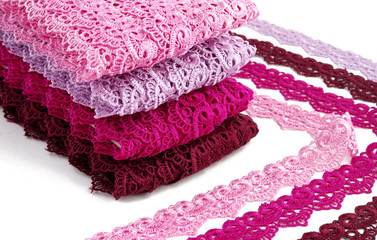 Reddish lace stretched over white background