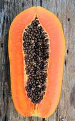 Sliced fresh papaya on wooden background