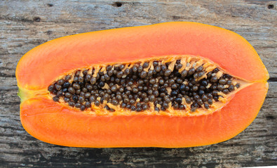 Sliced fresh papaya on wooden background