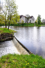 Fototapeta na wymiar Waterfall near the medieval castle in Jaunpils,Latvia