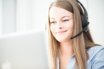 Female consultant using headphones - 104651829