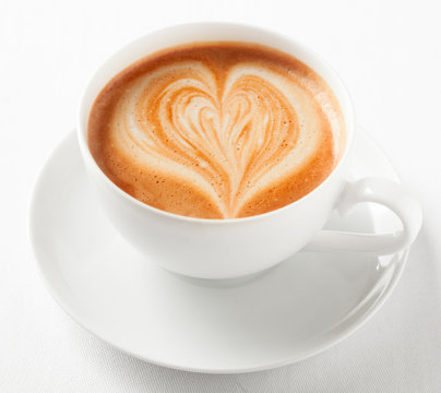 Cup of art cappuccino with a decorative heart