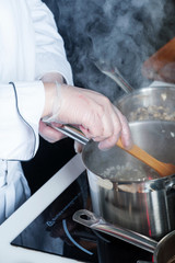 Pans in the kitchen, the cook hands.