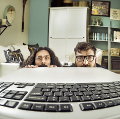 Two funny computer scientits staring at a keybord - 104654019