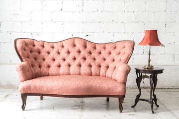 vintage sofa and lamp on white wall.