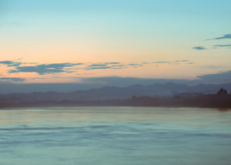 Fototapeta premium Blurry sunset sky over the river