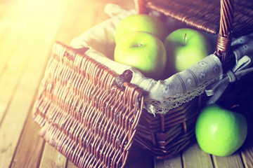 sunlight green apple in a basket wooden background