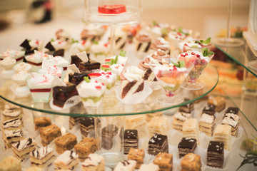 Different delicious desserts and cakes on the buffet table