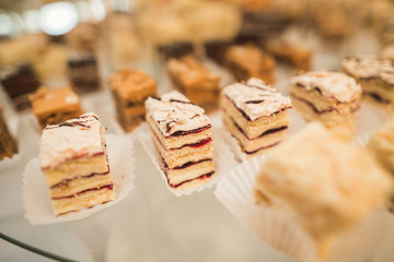 Different delicious desserts and cakes on the buffet table