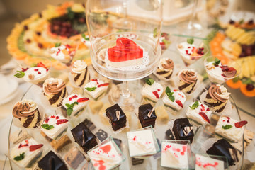 Different delicious desserts and cakes on the buffet table