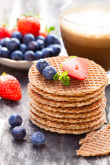 Stack  of Dutch caramel waffles with blueberry and strawberry wi