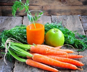 Fresh juice of organic carrots and apples. Rustic style. Selective focus.