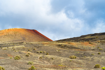 Lanzarote Island one of seven Canary Islands in Atlantic Ocean. Extraordinary volcano landscape with black and reddish rocks, soils and rugged lava formations, for travel and nature blog, magazines